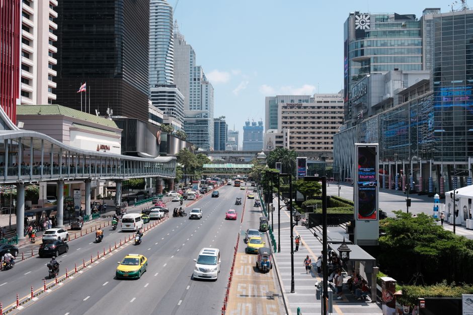 High-angle view of a busy urban street in Bangkok with modern architecture and traffic.