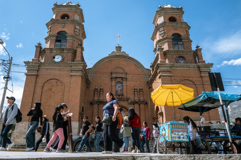 Vibrant street scene in Trujillo, Peru, featuring a historic colonial church and bustling local activity.